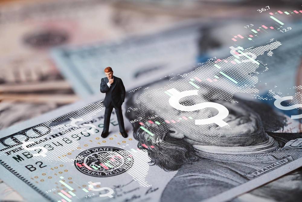 Businessman miniature figure standing on USD Businessman miniature figure standing on USD