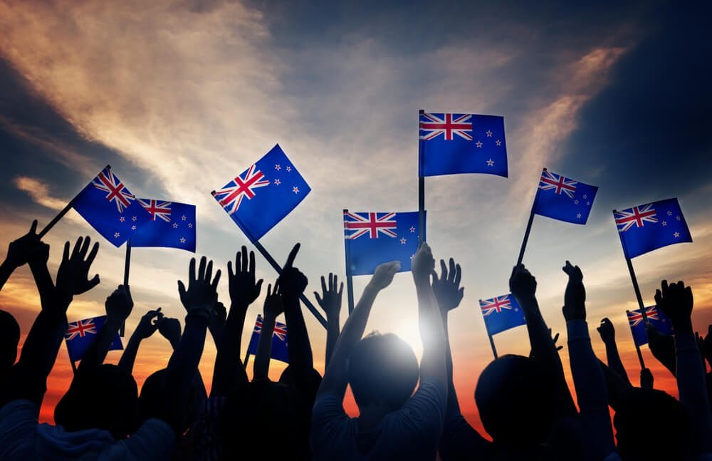 People Holding Flag of New Zealand People Holding Flag of New Zealand