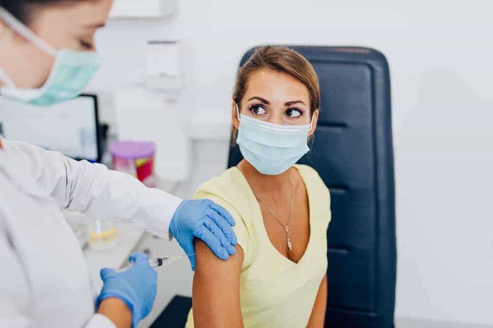 coronavirus vaccine injected to the female wearing mask coronavirus vaccine injected to the female wearing mask