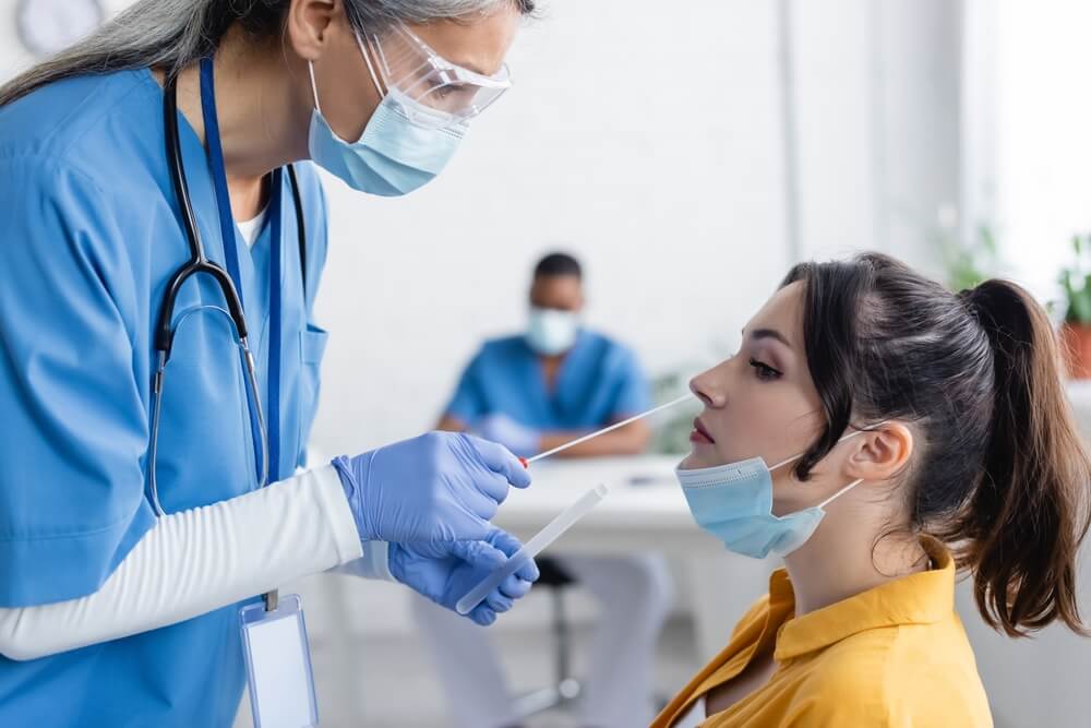 omicron virus treatment by doctor to patient inserting into nose omicron virus treatment by doctor to patient inserting into nose